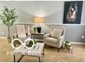 Finished basement with two armchairs, ottoman, and a lamp at 5634 Dapple Ct, Indianapolis, IN 46228