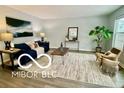 Living room with blue couch, wood coffee table, and area rug at 5634 Dapple Ct, Indianapolis, IN 46228