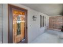 Front entrance with wood door, porch light, and wooden bench at 8403 Lookout Ct, Indianapolis, IN 46217