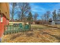Large backyard offering a green deck with seating, a shed, and mixed fencing at 10905 College Place Dr, Carmel, IN 46280