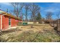 Expansive backyard showcasing a green deck, shed, and a combination of fencing styles at 10905 College Place Dr, Carmel, IN 46280