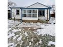 Snow-covered ranch home with white siding, blue trim, and a sunroom at 3305 S New Jersey St, Indianapolis, IN 46227