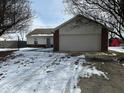 House exterior showcasing a garage and winter landscaping at 3371 Lauren Dr, Indianapolis, IN 46235