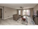 Spacious living room with neutral walls, flooring and ceiling fan and outside access at 352 Parkview Dr, Danville, IN 46122