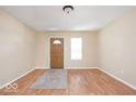 Inviting living room with warm-toned walls and a front door at 3614 E New York St, Indianapolis, IN 46201
