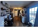 Kitchen with white cabinets, dark countertops, and access to backyard at 4651 Maplelawn Dr, Columbus, IN 47203