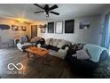 Spacious living room with beige couch and hardwood floors at 4651 Maplelawn Dr, Columbus, IN 47203