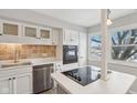Modern kitchen with white cabinets, stainless steel appliances and an island at 5152 Coppertree Ln, Avon, IN 46123