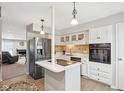 Modern kitchen with white cabinets, stainless steel appliances and an island at 5152 Coppertree Ln, Avon, IN 46123