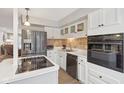 Modern kitchen with white cabinets, stainless steel appliances and an island at 5152 Coppertree Ln, Avon, IN 46123