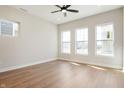 Bright bedroom featuring hardwood floors, a ceiling fan, and plenty of natural light from multiple windows at 525 Gilder Dr, Carmel, IN 46032