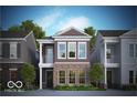 Two-story home with brick and siding exterior, balcony, and landscaping at 525 Gilder Dr, Carmel, IN 46032