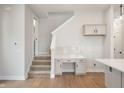 Open-concept space with stairs, built-in desk, and hardwood floors at 525 Gilder Dr, Carmel, IN 46032