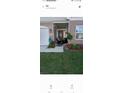 Inviting front porch with colorful flower arrangements and decorative hanging planters at 5278 Bramwell Ln, Whitestown, IN 46075