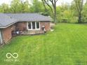 Exterior of the home with a walkout and a large grass filled backyard at 5420 Skyridge Dr, Indianapolis, IN 46250