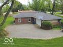 Rear exterior featuring a two car garage with a basketball hoop and parking at 5420 Skyridge Dr, Indianapolis, IN 46250