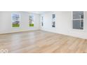 Spacious living room with hardwood floors and large windows at 5751 Cr W 750 N, McCordsville, IN 46055