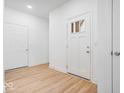 Bright foyer with light hardwood floors and white doors at 5767 Cr W 750 N, McCordsville, IN 46055