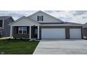 Attractive single-story brick home featuring a two-car garage and manicured front lawn at 6033 Granby Dr, Whitestown, IN 46075