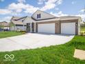 Charming one-story home with a spacious driveway and a three-car garage perfect for a growing Gathering at 6033 Granby Dr, Whitestown, IN 46075