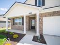 Close-up of the welcoming front porch with brick facade and a pathway leading to the front door at 6033 Granby Dr, Whitestown, IN 46075