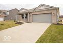 Beautiful single-story home with a two-car garage and a long concrete driveway at 6047 Granby Dr, Whitestown, IN 46075