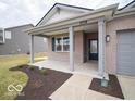 Inviting covered front porch with brick columns and a view of the landscaped yard at 6047 Granby Dr, Whitestown, IN 46075