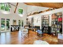 Bright living room with a wood ceiling, built-in bookshelves, and French doors leading to the outdoors at 6377 N Tutterow Rd, Monrovia, IN 46157