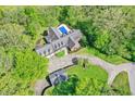 Expansive estate featuring a large home, pool, circular drive, and lush greenery at 8602 Frontgate Ln, Indianapolis, IN 46256