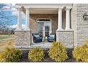 Cozy covered porch with wicker chairs and landscaping at 14292 Dufton Ct, Carmel, IN 46074