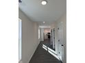 Bright hallway with neutral walls and wood-look flooring leads to the kitchen at 1440 Wigwam Ln, Martinsville, IN 46151