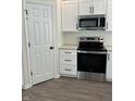 Modern kitchen features stainless steel appliances, white cabinets, and granite countertops at 1440 Wigwam Ln, Martinsville, IN 46151