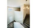 Elegant staircase with chandelier in a two-story foyer at 1644 Hunting Horn Cir, Indianapolis, IN 46260