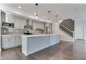 Modern kitchen with gray cabinets, stainless steel appliances, and an island at 2009 Carrollton Ave, Indianapolis, IN 46202