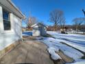 Backyard with shed and partially snow-covered patio at 2104 Drexel Dr, Anderson, IN 46011