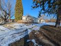 Side view of a ranch house with a deck, partially covered in snow at 2104 Drexel Dr, Anderson, IN 46011
