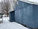 Blue house side exterior, snow on the ground at 2317 Fowler St, Anderson, IN 46012