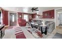 Cozy living room featuring a gray sofa, area rug, and a ceiling fan at 233 S Routiers Ave, Indianapolis, IN 46219