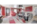 Spacious living room with gray sectional sofa, red accents, and a view of the kitchen at 233 S Routiers Ave, Indianapolis, IN 46219