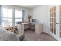 Home office with corner desk, comfortable chairs, and plenty of natural light at 2406 Ninebark Dr, Plainfield, IN 46168