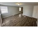 Spacious living room with dark wood-look floors and neutral walls at 2442 Asbury St, Indianapolis, IN 46203