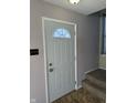 Interior entryway with a white door and carpeted stairs at 2507 Redland Ln, Indianapolis, IN 46217