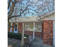 Inviting front porch of a red brick house with a view of the garden at 2509 W Euclid Ave, Muncie, IN 47304