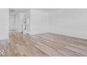 Bright, open-concept living room featuring hardwood floors and neutral wall paint at 385 N Post Oak Dr, Mooresville, IN 46158