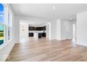Spacious living room showcasing hardwood floors and an open floor plan to the kitchen at 385 N Post Oak Dr, Mooresville, IN 46158