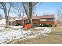 Ranch house with a red swing and basketball hoop in the yard at 3909 S Lasalle St, Indianapolis, IN 46237