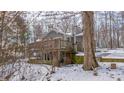 Gray house with large deck and snowy yard, partially obscured by a tree at 55 Peavine Rd, Martinsville, IN 46151