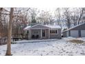 Gray house with detached garage and snowy yard at 55 Peavine Rd, Martinsville, IN 46151