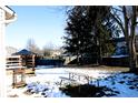 Fenced backyard with deck, picnic table, and partially covered pool at 6121 E Solitude Ct, Camby, IN 46113