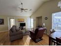 Living room with hardwood floors, vaulted ceiling, and comfortable seating at 706 Shagbark Ct, Plainfield, IN 46168